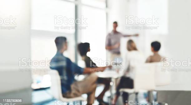 Defocused shot of a group of businesspeople having a meeting in an office